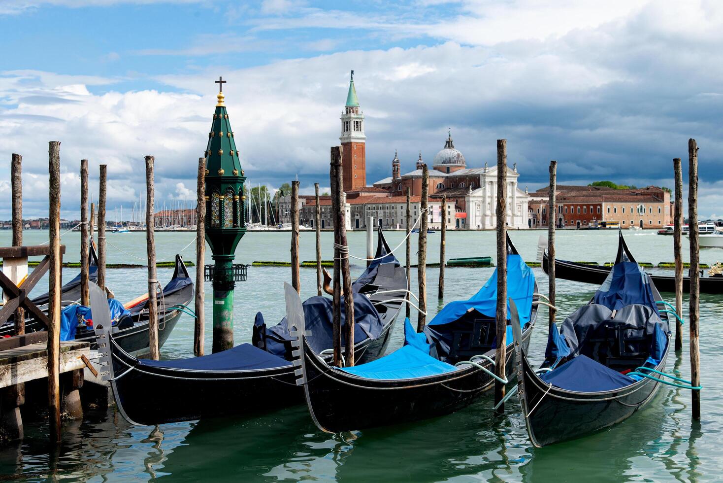 Venice, Italy-April 24, 2024 Gondolas Moored with San Giorgio Maggiore View photo