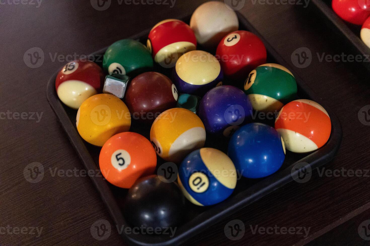 Billiard balls are organized in a rack ready for the game photo