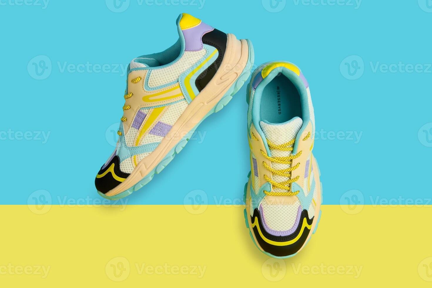 White sneakers with colored accents on bright background, Pair of fashionable sport shoes with colorful backdrop. Studio shot of shoes for shop advertisement, creative minimalist style photo