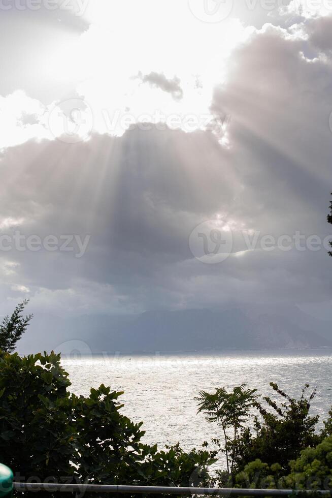 sun rays from behind clouds photo