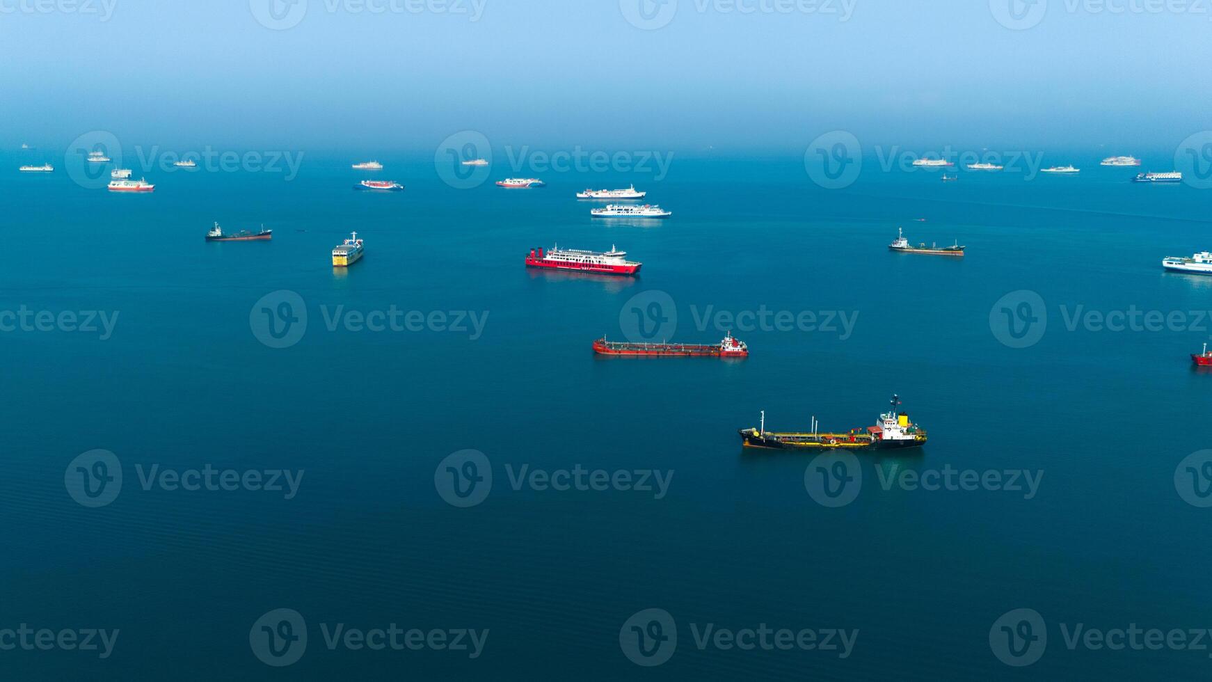 Serene seascape with a fleet of cargo ships dotting the tranquil blue ocean, capturing the essence of maritime logistics and global trade photo