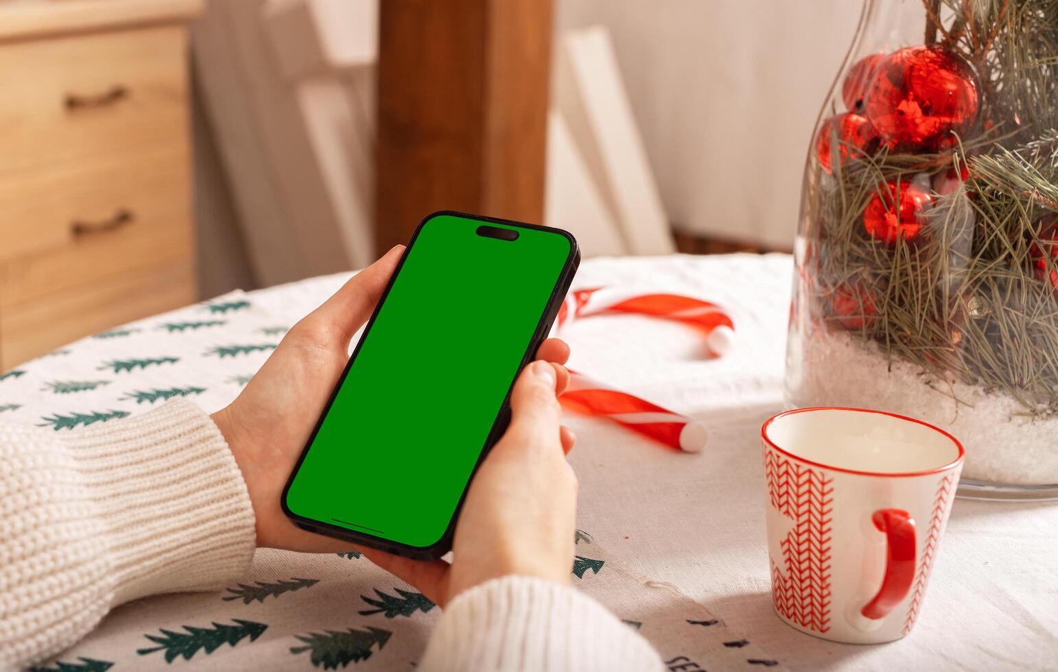 Lodz Poland July 20 2024 Hand holding mobile phone mockup, iphone screen mock up, Christmas holiday photo