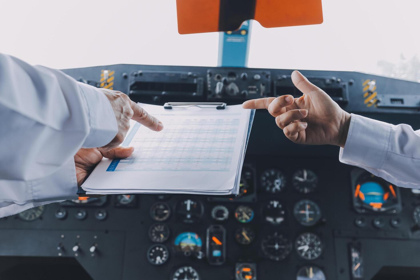 Professional pilot woman in uniform has teamwork meeting for success flight in aviation business. Young female captain instructor sitting in office and working or training commercial airline crew. photo