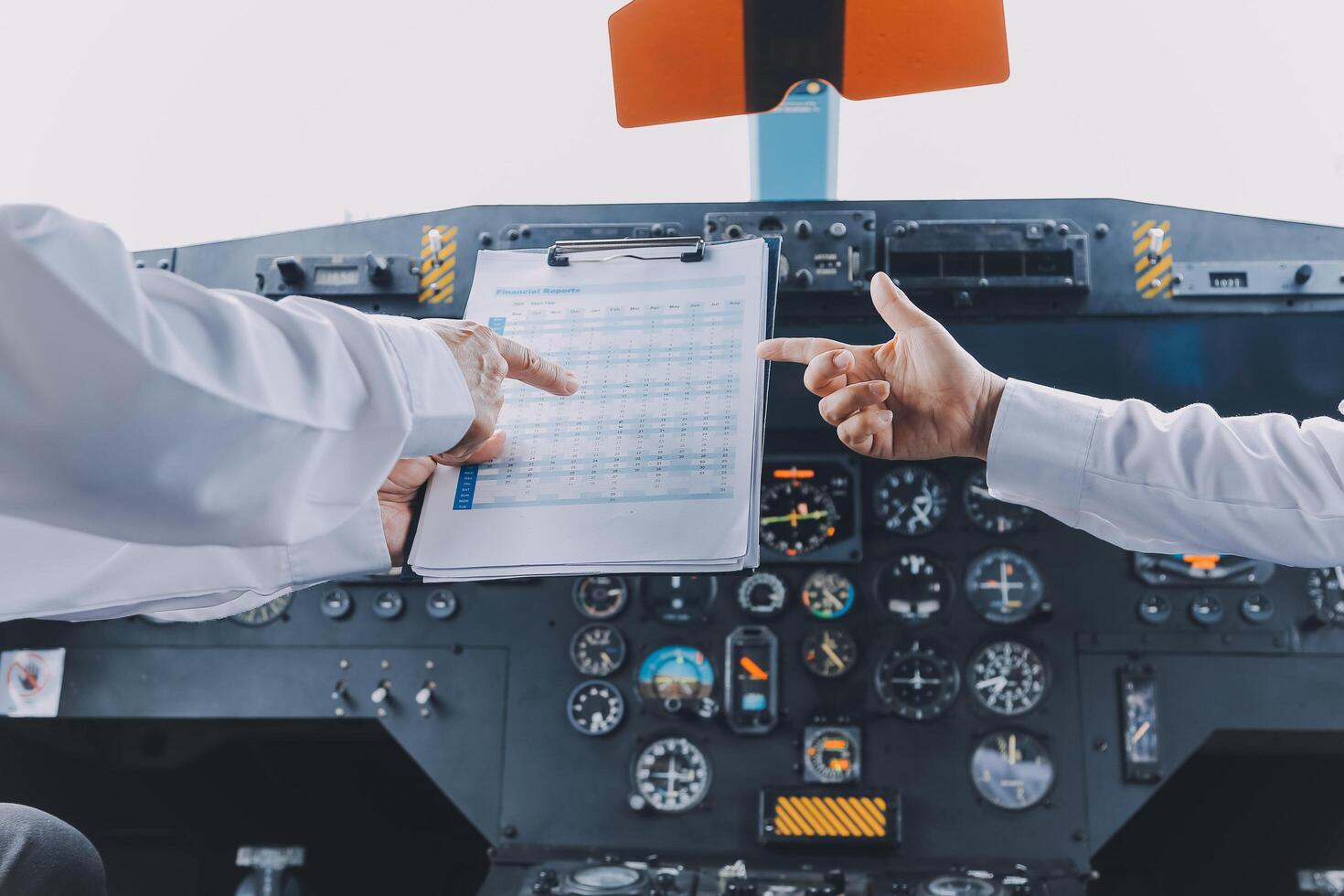 Professional pilot woman in uniform has teamwork meeting for success flight in aviation business. Young female captain instructor sitting in office and working or training commercial airline crew. photo