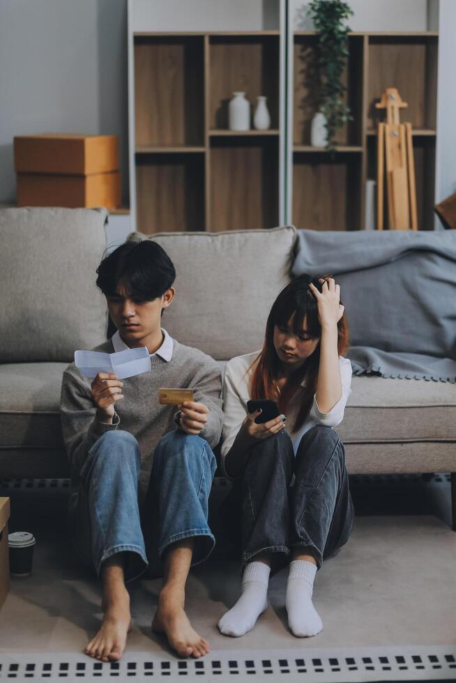 Worried annoyed young husband wife using phone credit card dissatisfied with interrupted wifi internet connection slow bad app work. Angry family couple bank clients unable to pay online check balance photo