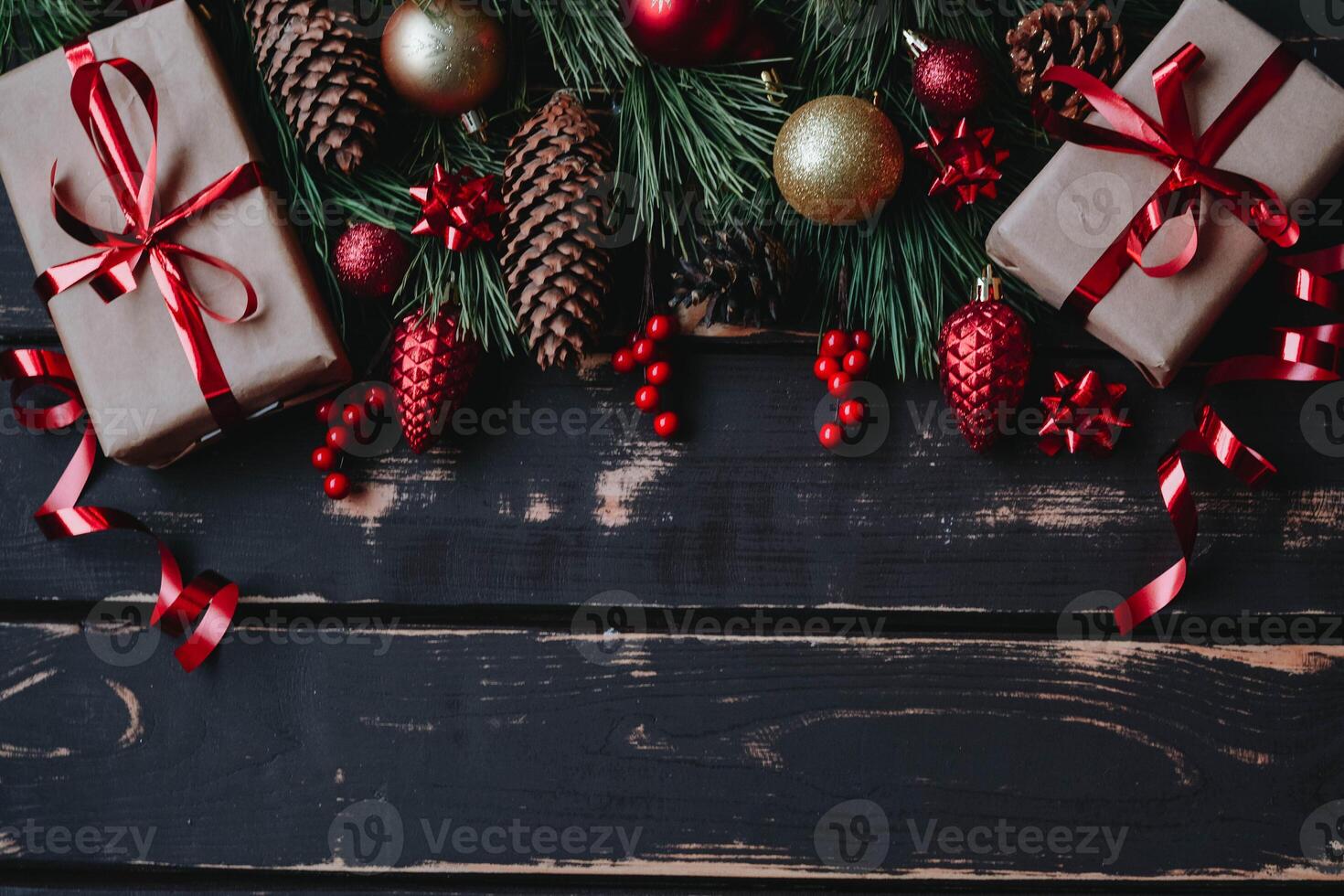 Top view photo Christmass flatlay gift boxes,red and gold christmas tree toys and spruce brance on wooden background. Xmas backdrop with space for text.Copyspace.Vertical photo.