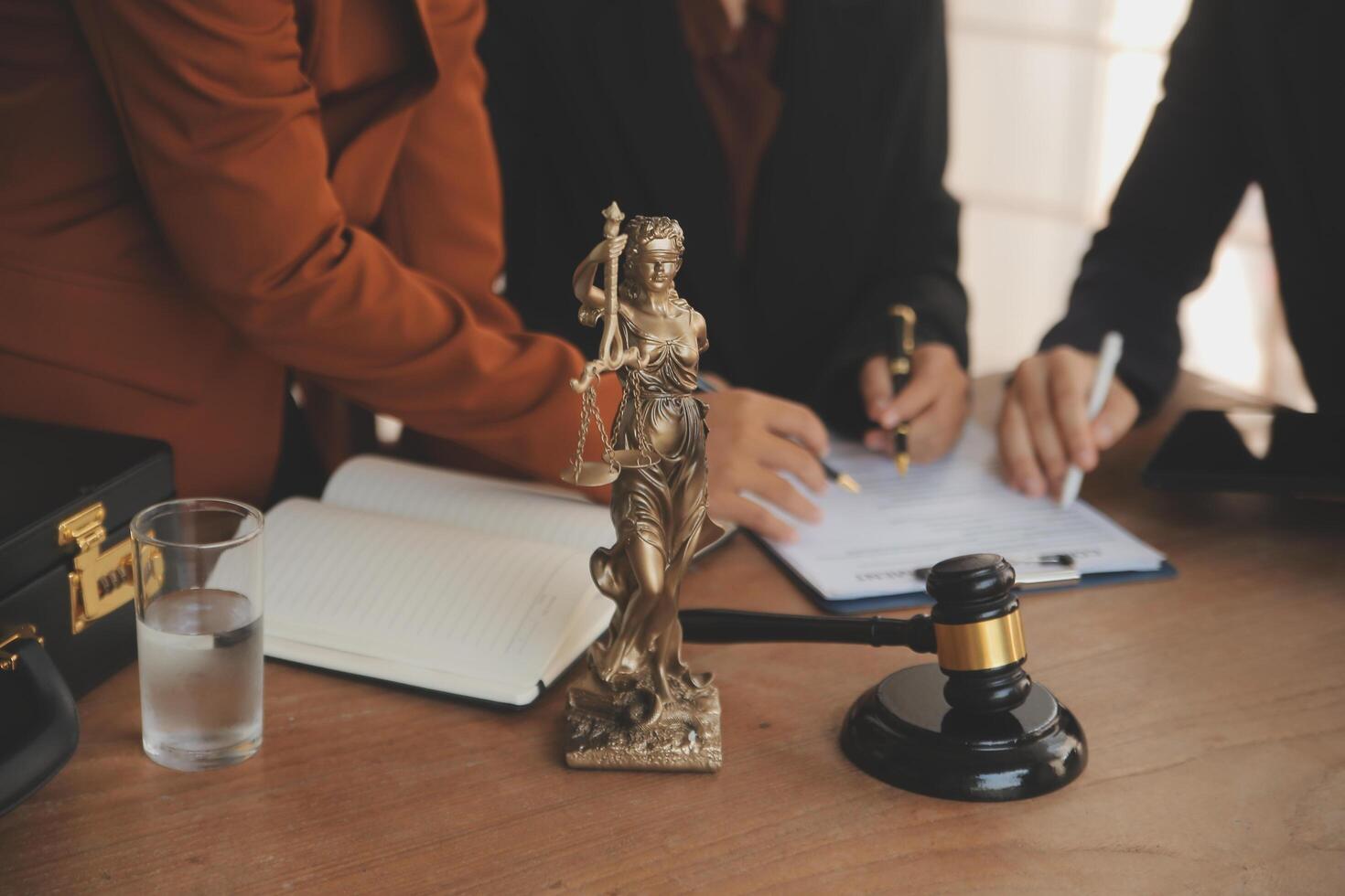Lawyer, legal advisor, businessman brainstorming information on agreement details Business contracts in legal processing books for accuracy in contract documents. joint financial investment. photo