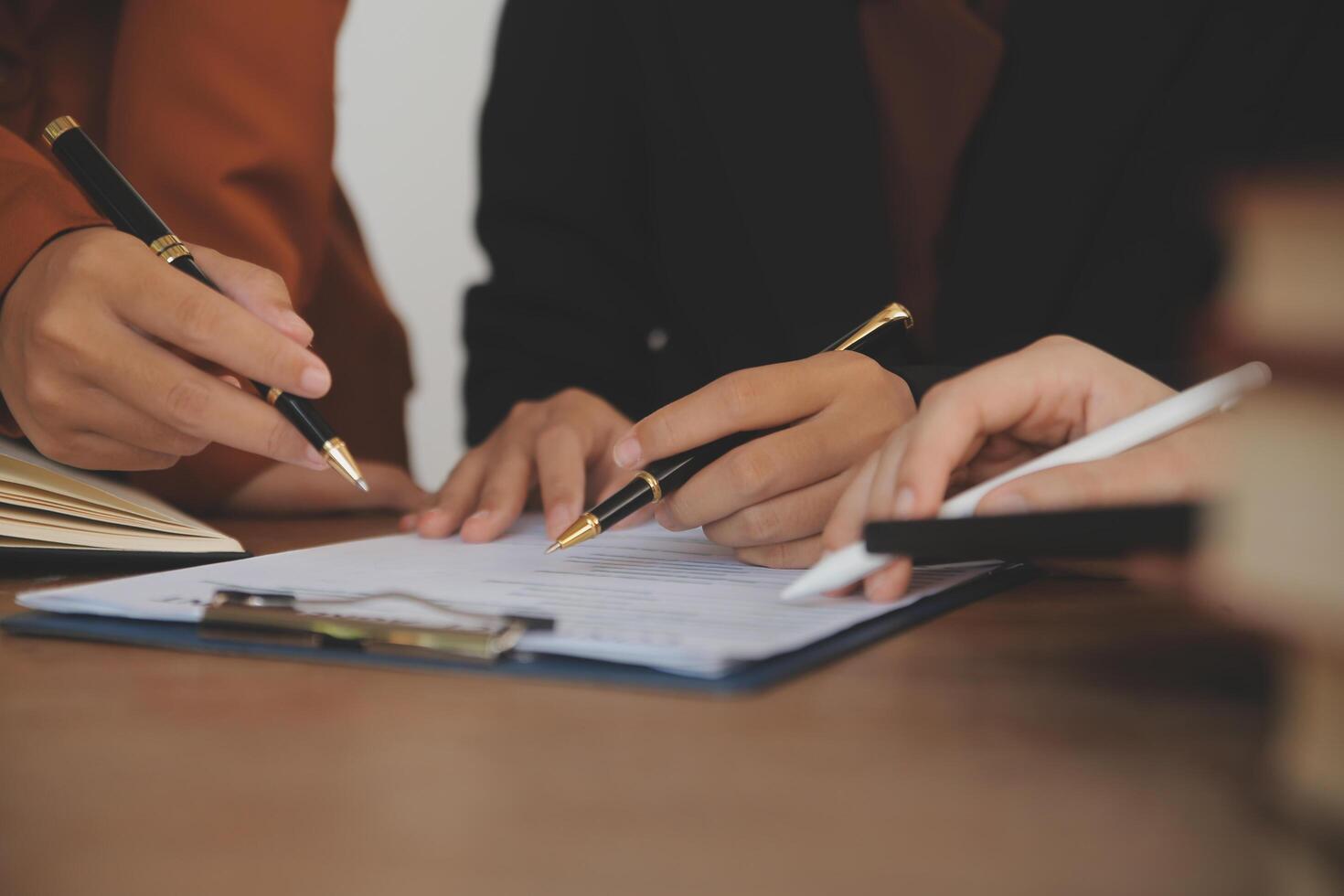 Lawyer, legal advisor, businessman brainstorming information on agreement details Business contracts in legal processing books for accuracy in contract documents. joint financial investment. photo