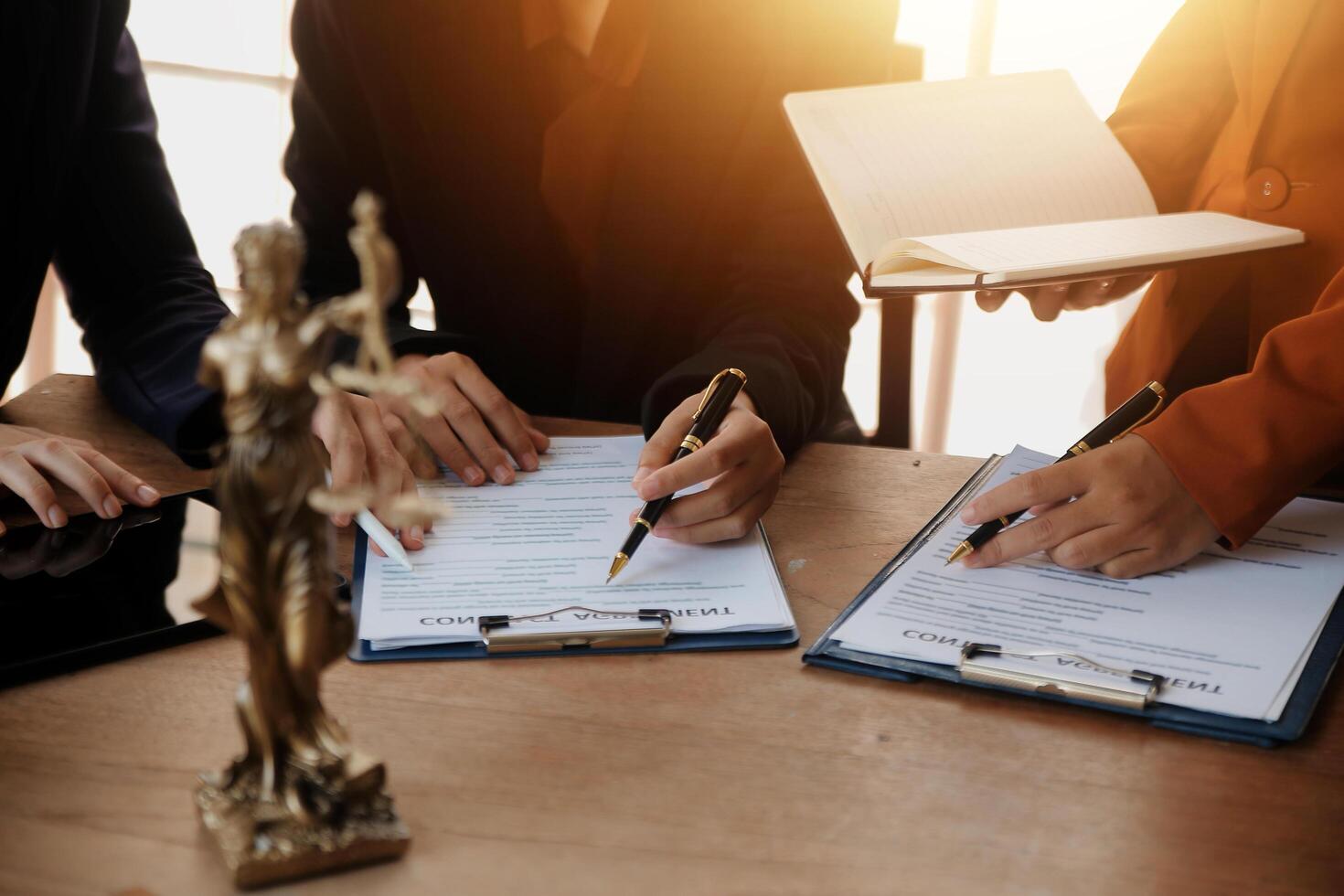Lawyer, legal advisor, businessman brainstorming information on agreement details Business contracts in legal processing books for accuracy in contract documents. joint financial investment. photo