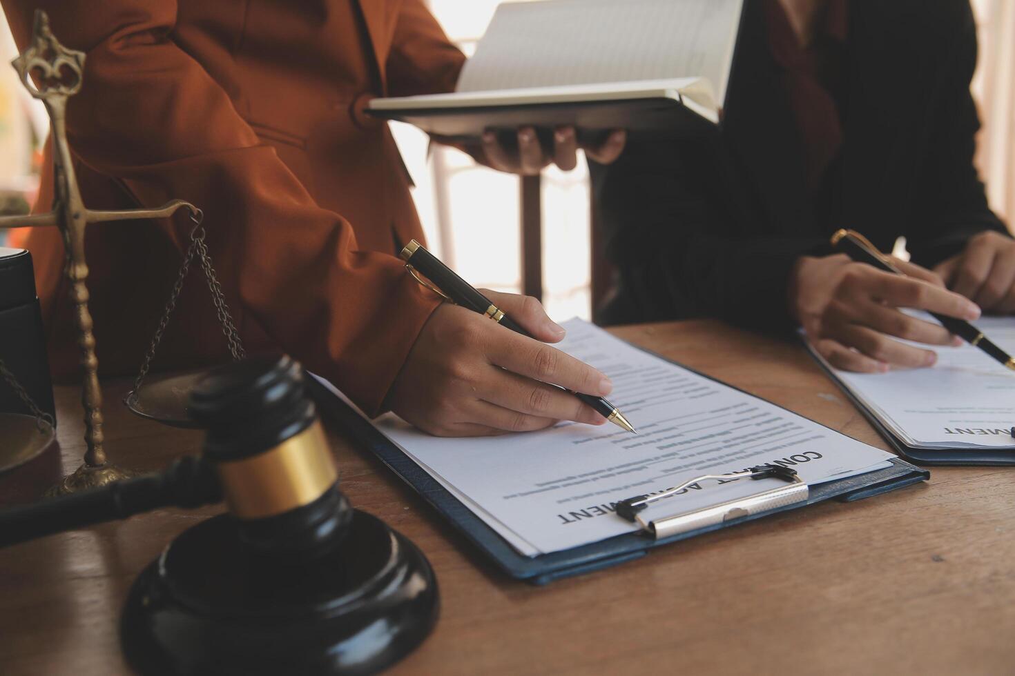 Lawyer, legal advisor, businessman brainstorming information on agreement details Business contracts in legal processing books for accuracy in contract documents. joint financial investment. photo