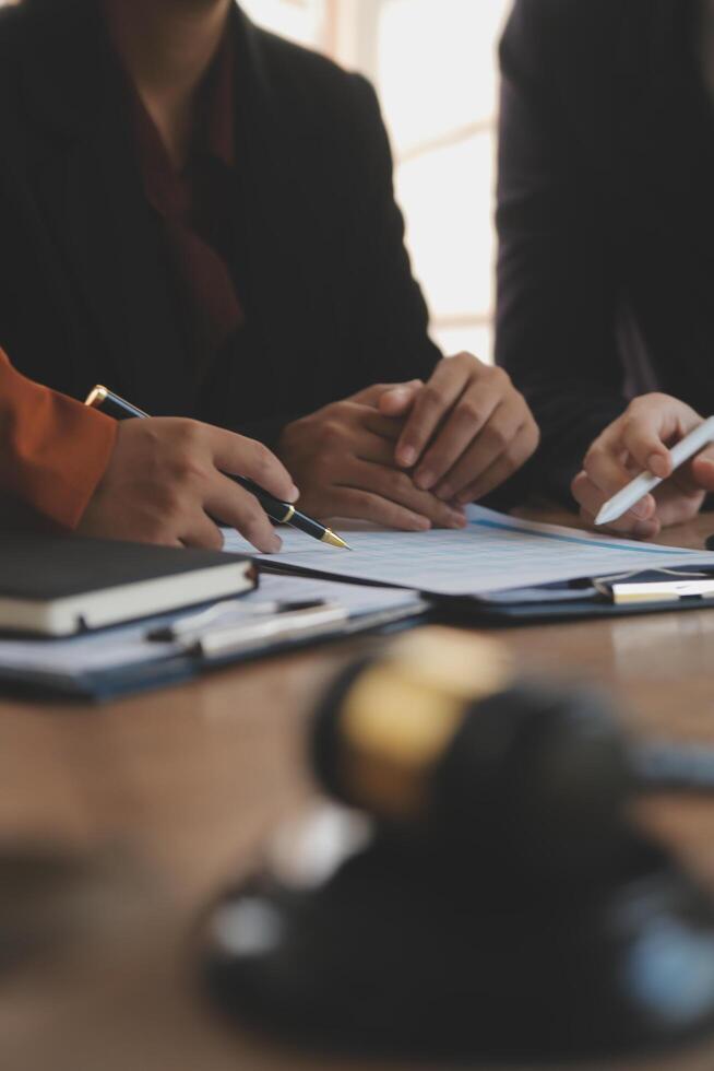 Lawyer, legal advisor, businessman brainstorming information on agreement details Business contracts in legal processing books for accuracy in contract documents. joint financial investment. photo