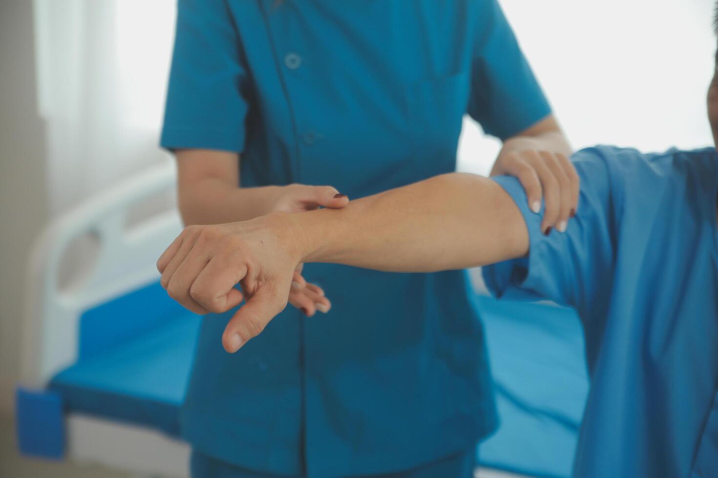 Physiotherapist man giving exercise with dumbbell treatment About Arm and Shoulder of athlete male patient Physical therapy concept photo