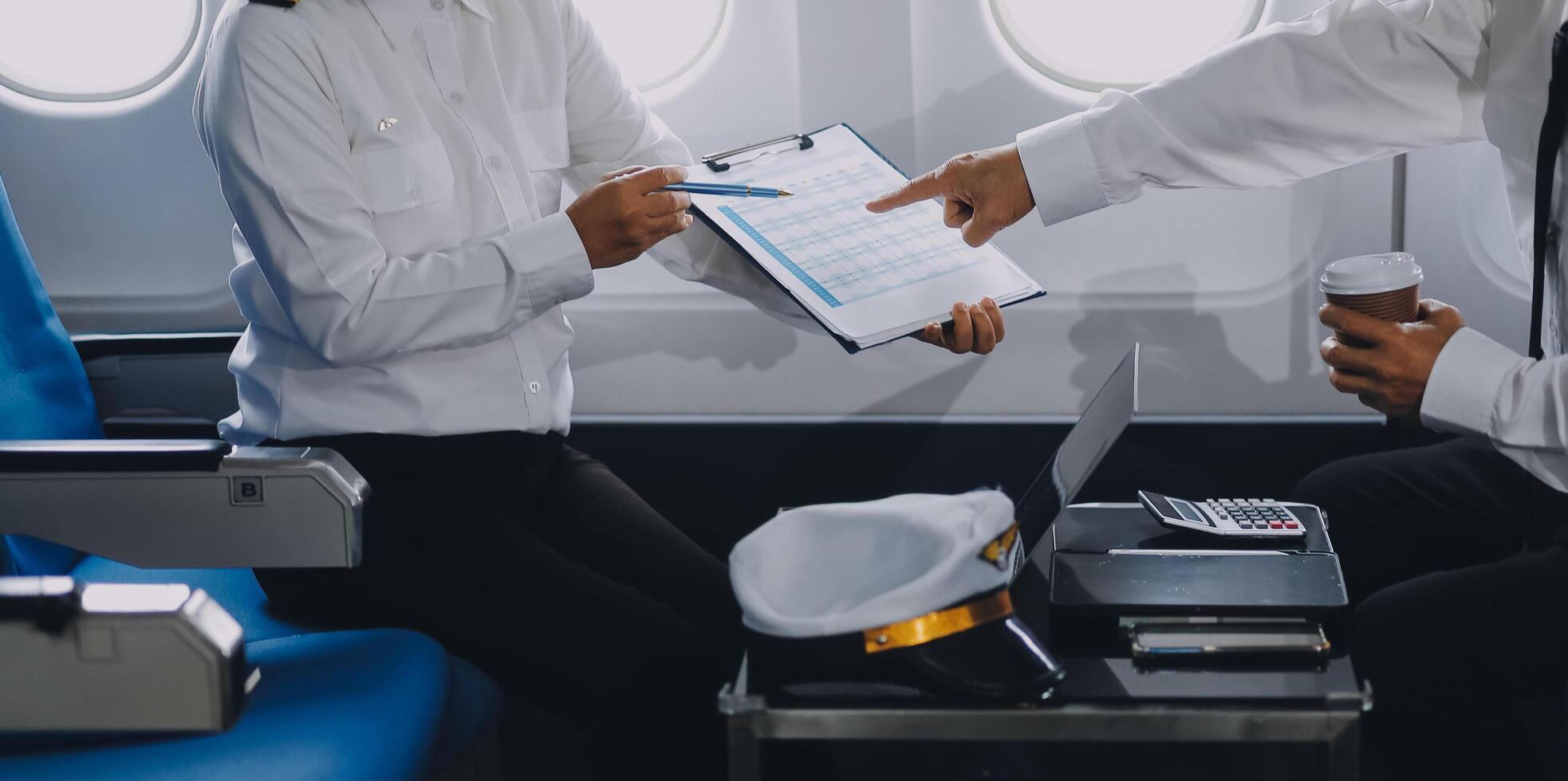 Professional pilot woman in uniform has teamwork meeting for success flight in aviation business. Young female captain instructor sitting in office and working or training commercial airline crew. photo
