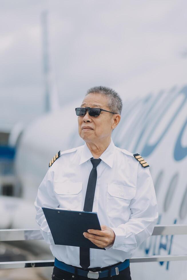 Professional pilot woman in uniform has teamwork meeting for success flight in aviation business. Young female captain instructor sitting in office and working or training commercial airline crew. photo
