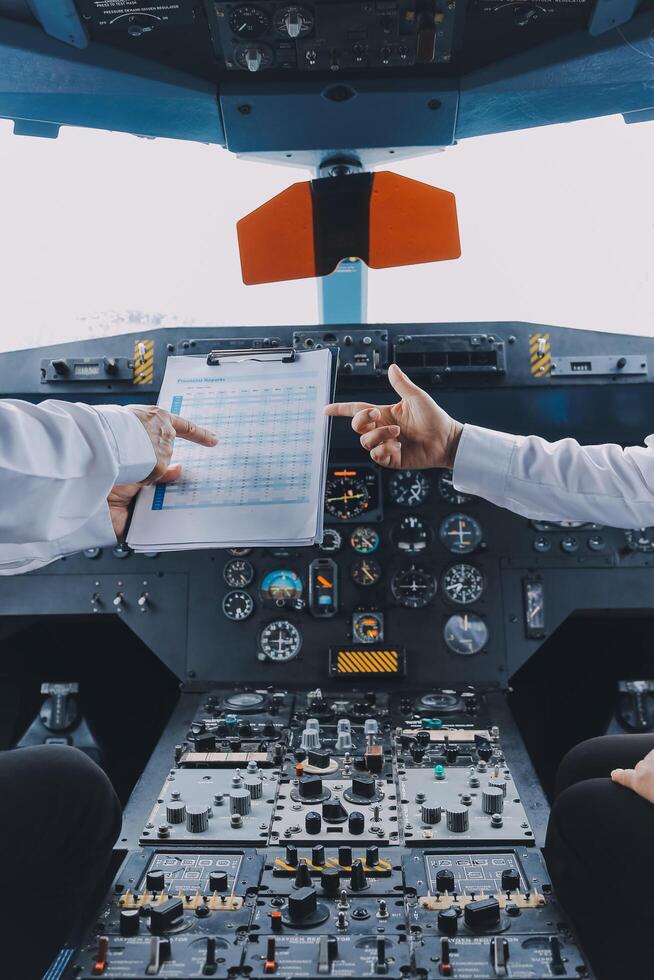 Professional pilot woman in uniform has teamwork meeting for success flight in aviation business. Young female captain instructor sitting in office and working or training commercial airline crew. photo