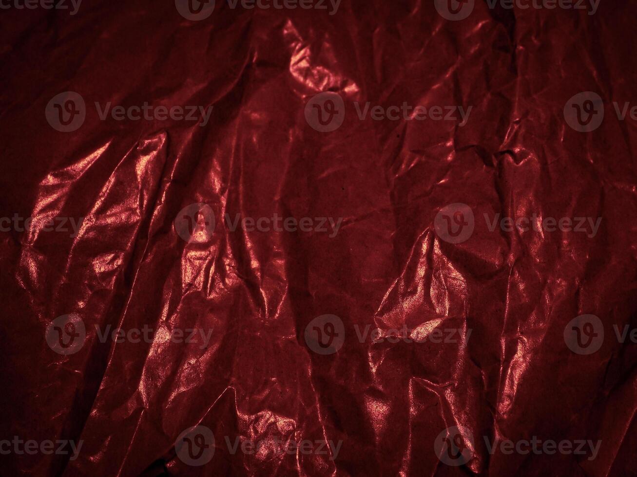 Wrinkled paper texture in dark red tones for a mysterious background. photo