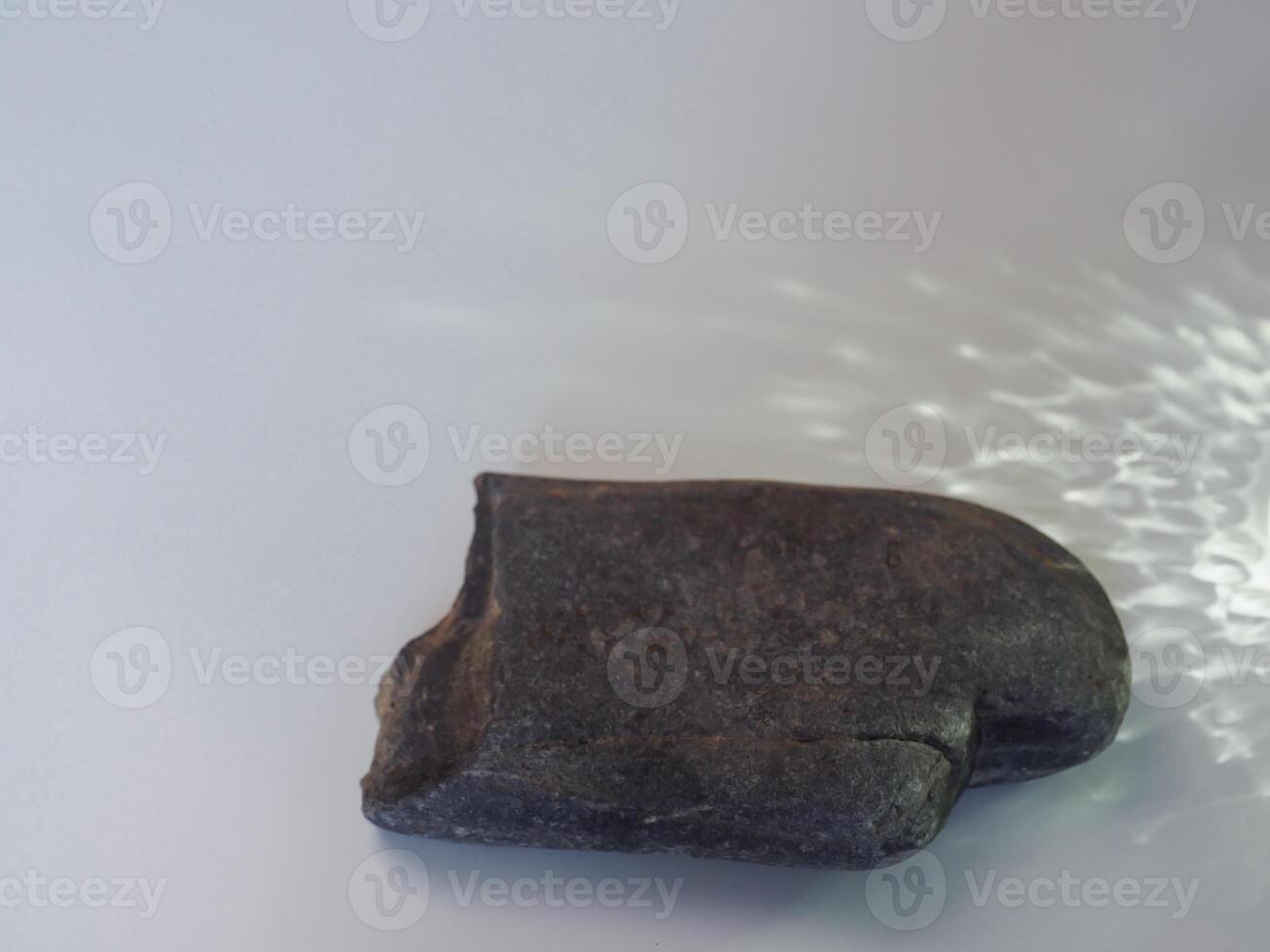 Rocks and reflections on a white background for a minimalist product background. photo