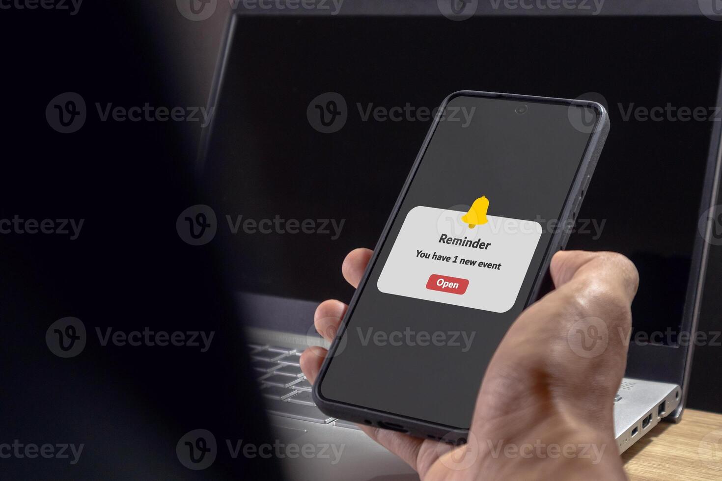 Man holding a mobile phone with reminder notifications page on screen. New event notice message on mobile phone. photo