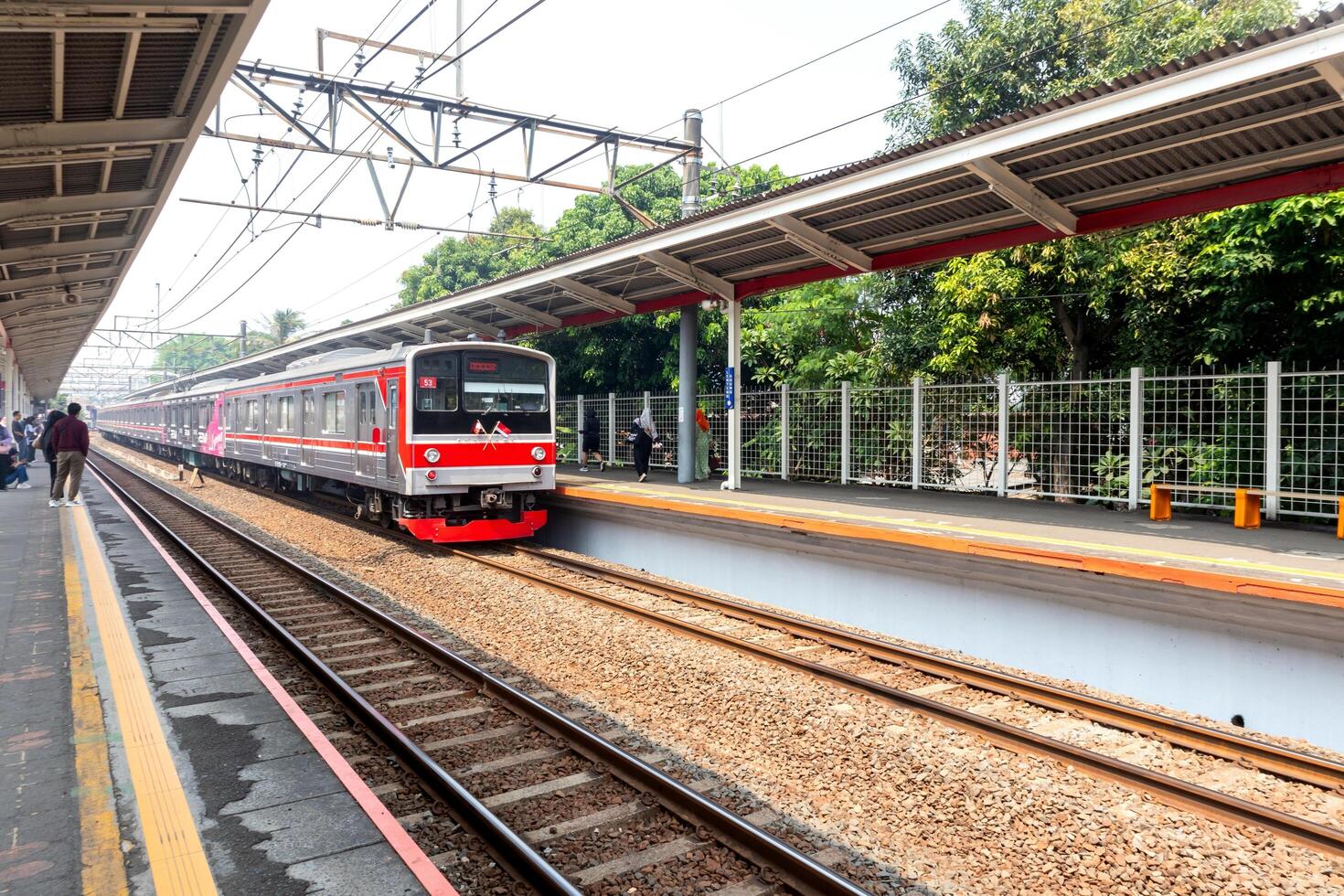 Jakarta, Indonesia, 2024 - The commuter train arrived at the station. Passengers prepare to get off and get on. photo