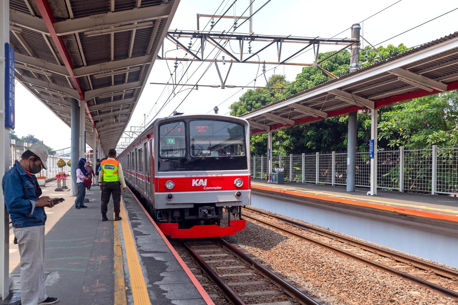 Jakarta, Indonesia, 2024 - The commuter train arrived at the station. Passengers prepare to get off and get on. photo