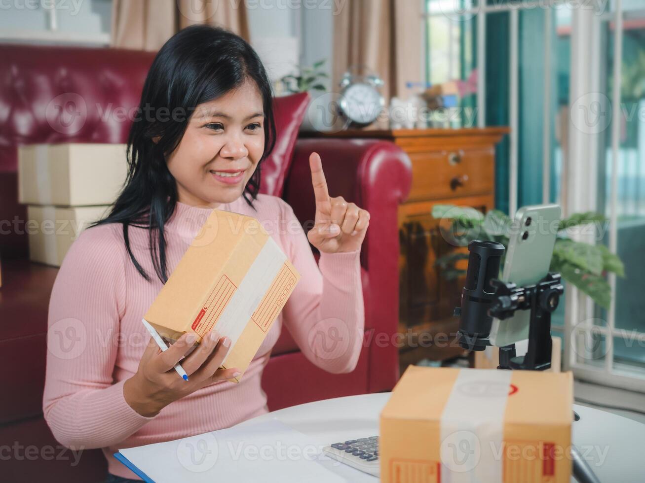 Live to sell products, woman blogger review products from camera on her phone, Business online influencer on social media concept, Ecommerce business live streaming vlog new normal concept. photo