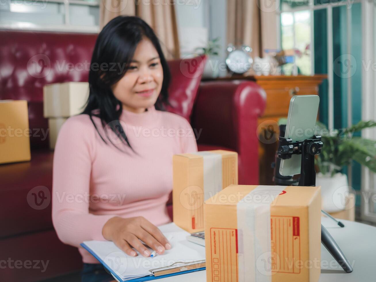 Asian blogger review products and camera on her phone, sell them online, Business online influencer on social media concept, Ecommerce business live streaming vlog new normal concept. photo