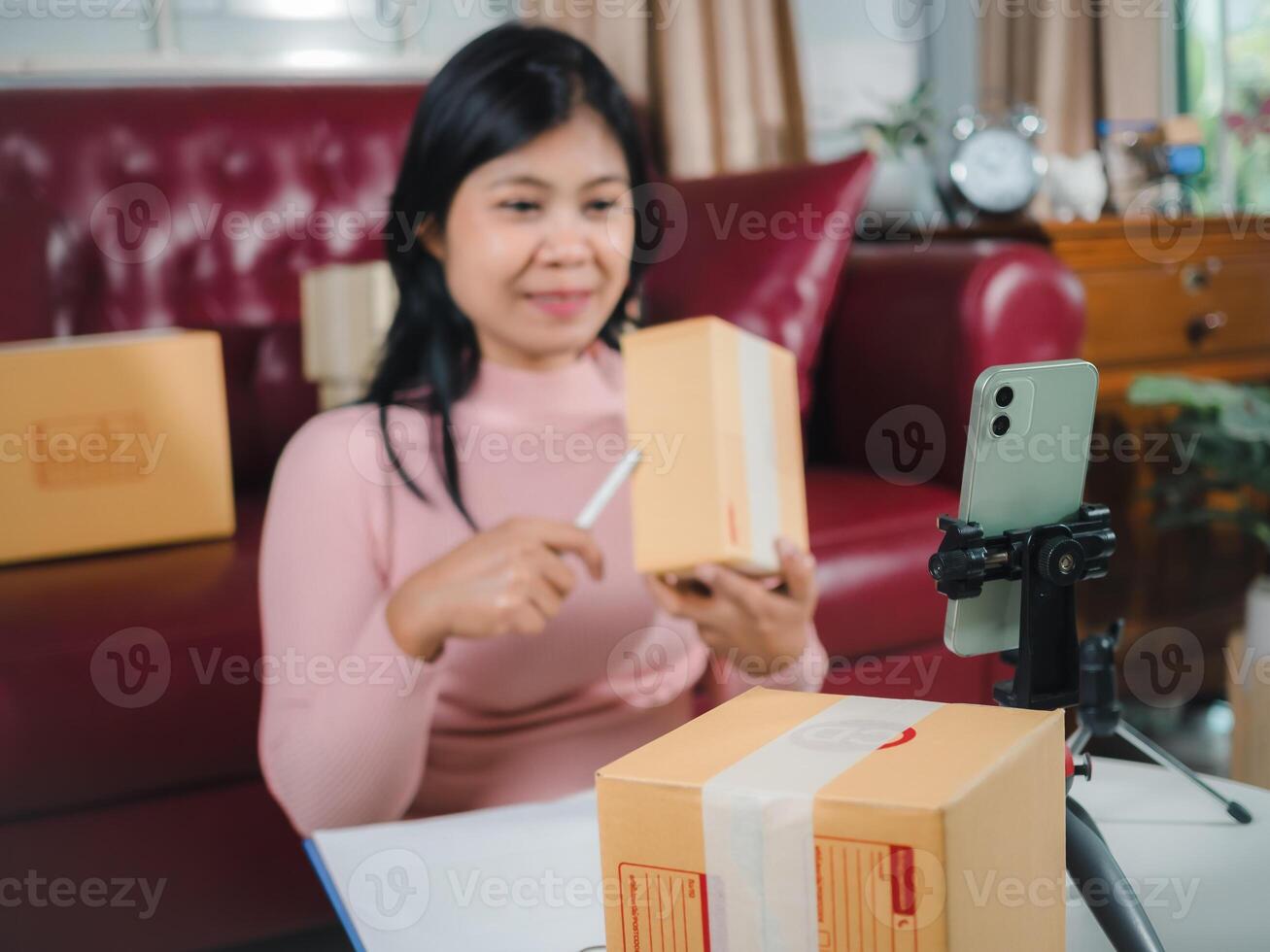 Asian blogger review products and camera on her phone, sell them online, Business online influencer on social media concept, Ecommerce business live streaming vlog new normal concept. photo
