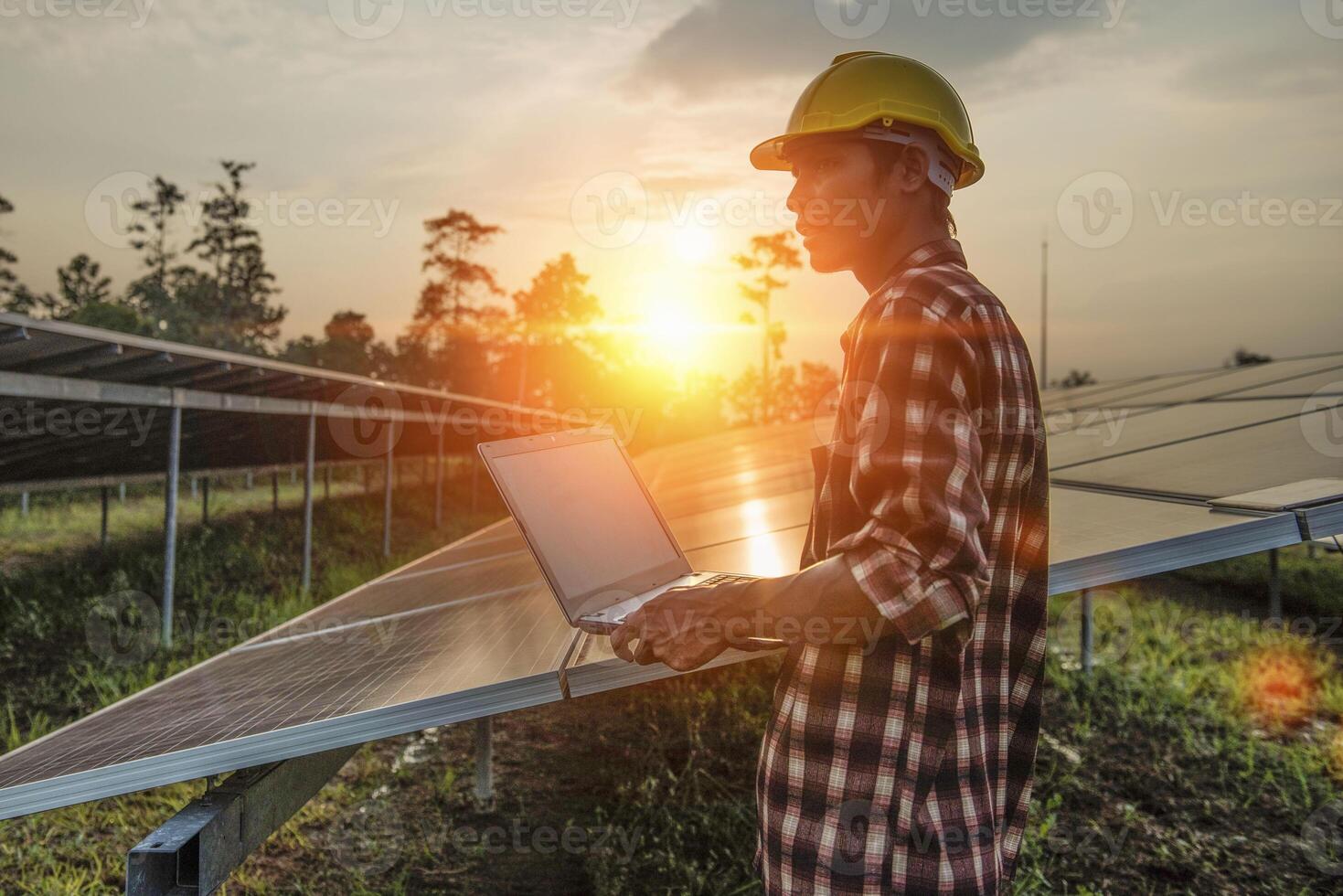 Male engineer working at high level to check efficiency of solar cell from clean solar cell which is friendly to environment. photo