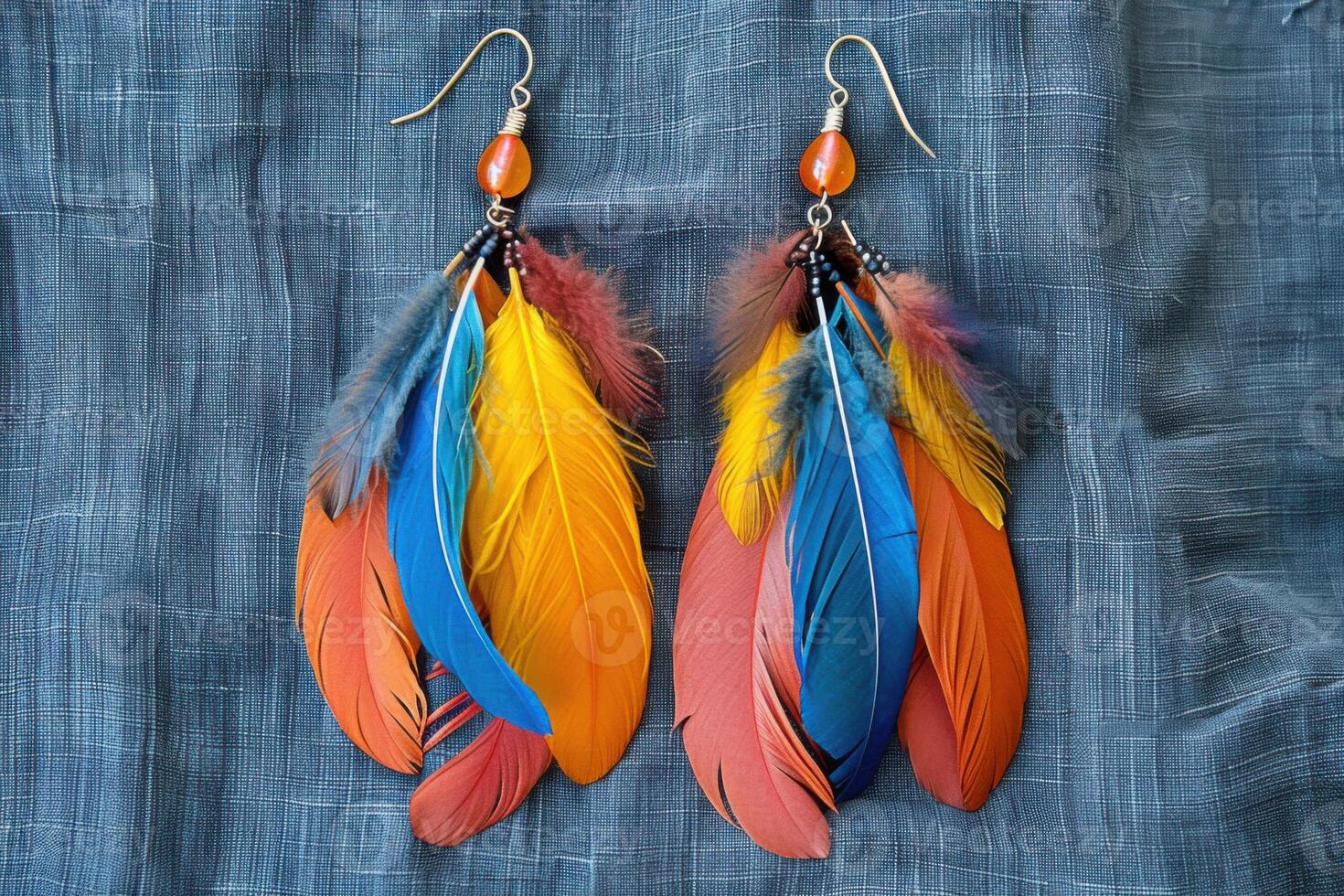 Colorful feather earrings displayed on a textured fabric background, close up view photo