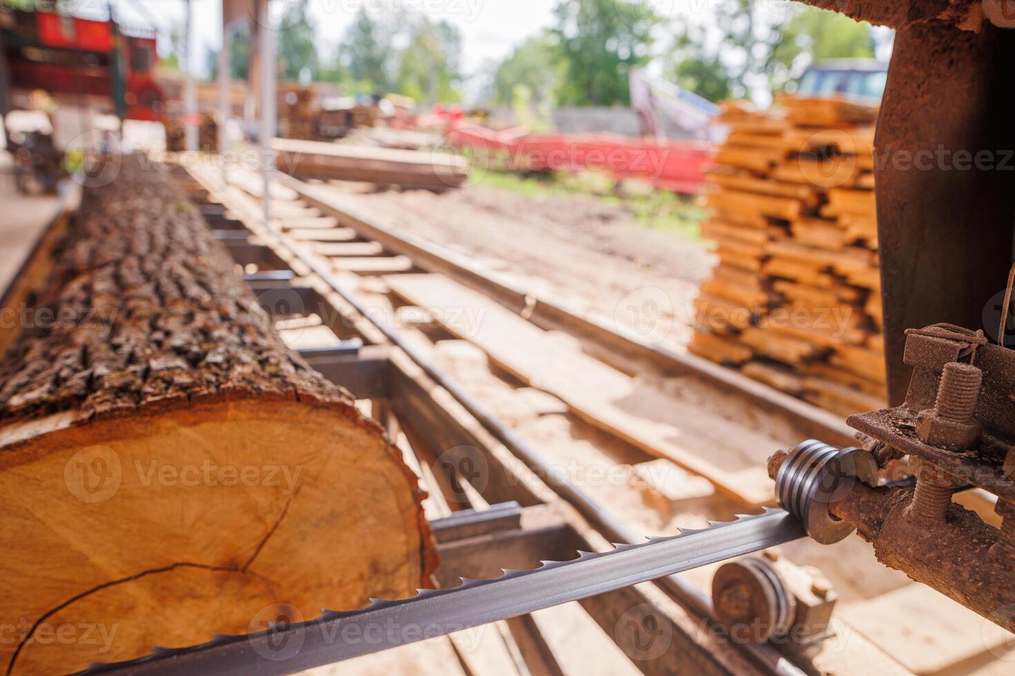 Close-Up of Band saw Cutting Log in Sawmill photo