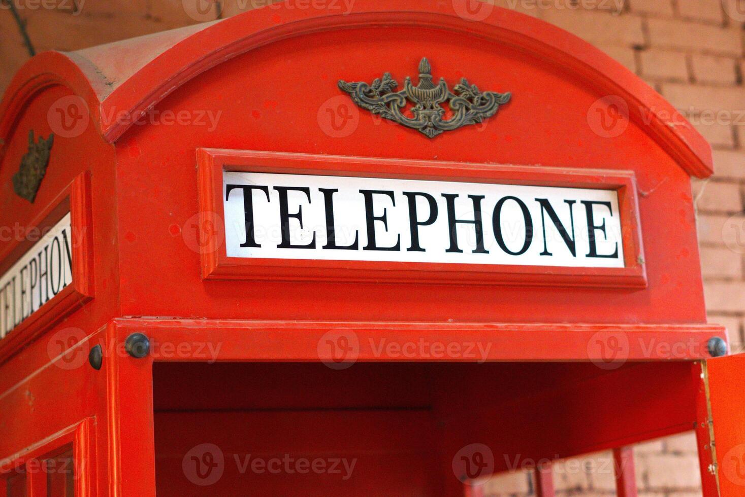text on red telephone booth public payphone box photo