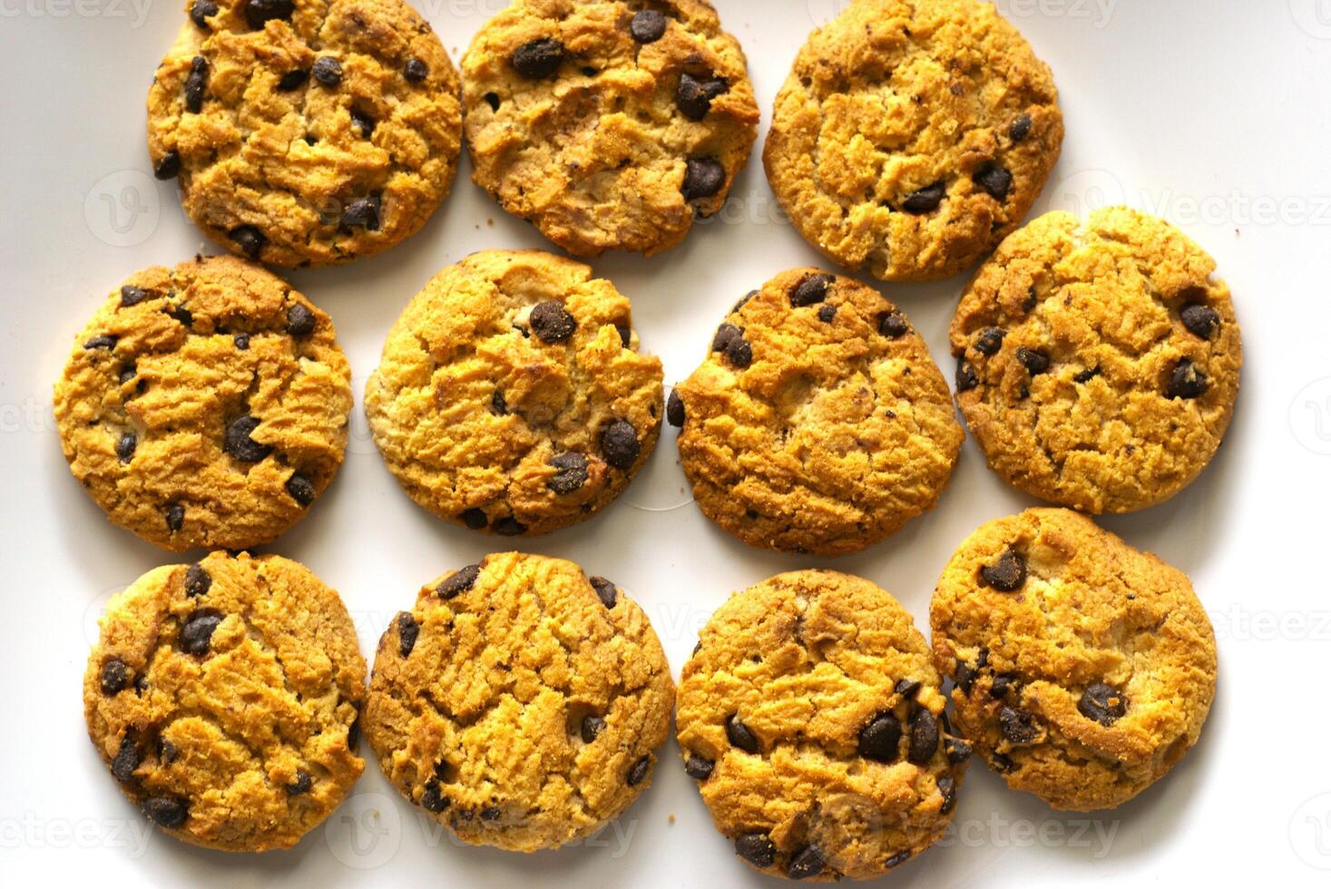 heap of chocolate chip cookies isolated on white background photo