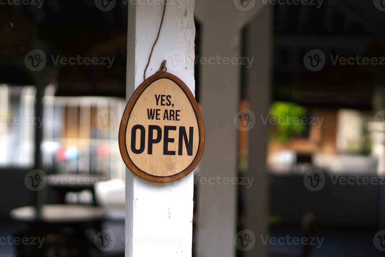 We are open text sign hanging on a restaurant photo