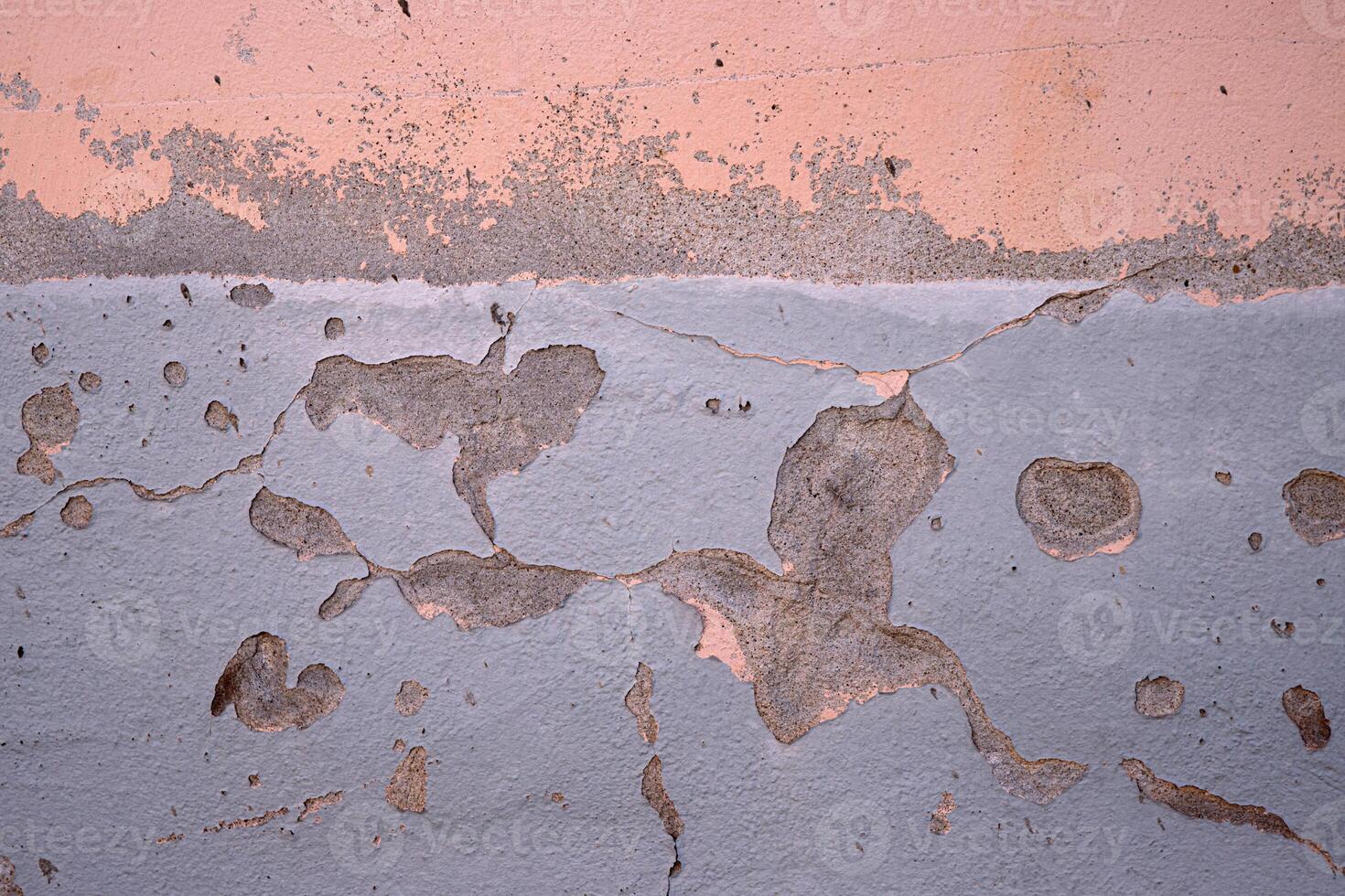 Weathered wall with peeling paint in pastel pink and gray. Ideal for backgrounds, urban photography, grunge textures, vintage aesthetics, creative design elements. Copy space photo