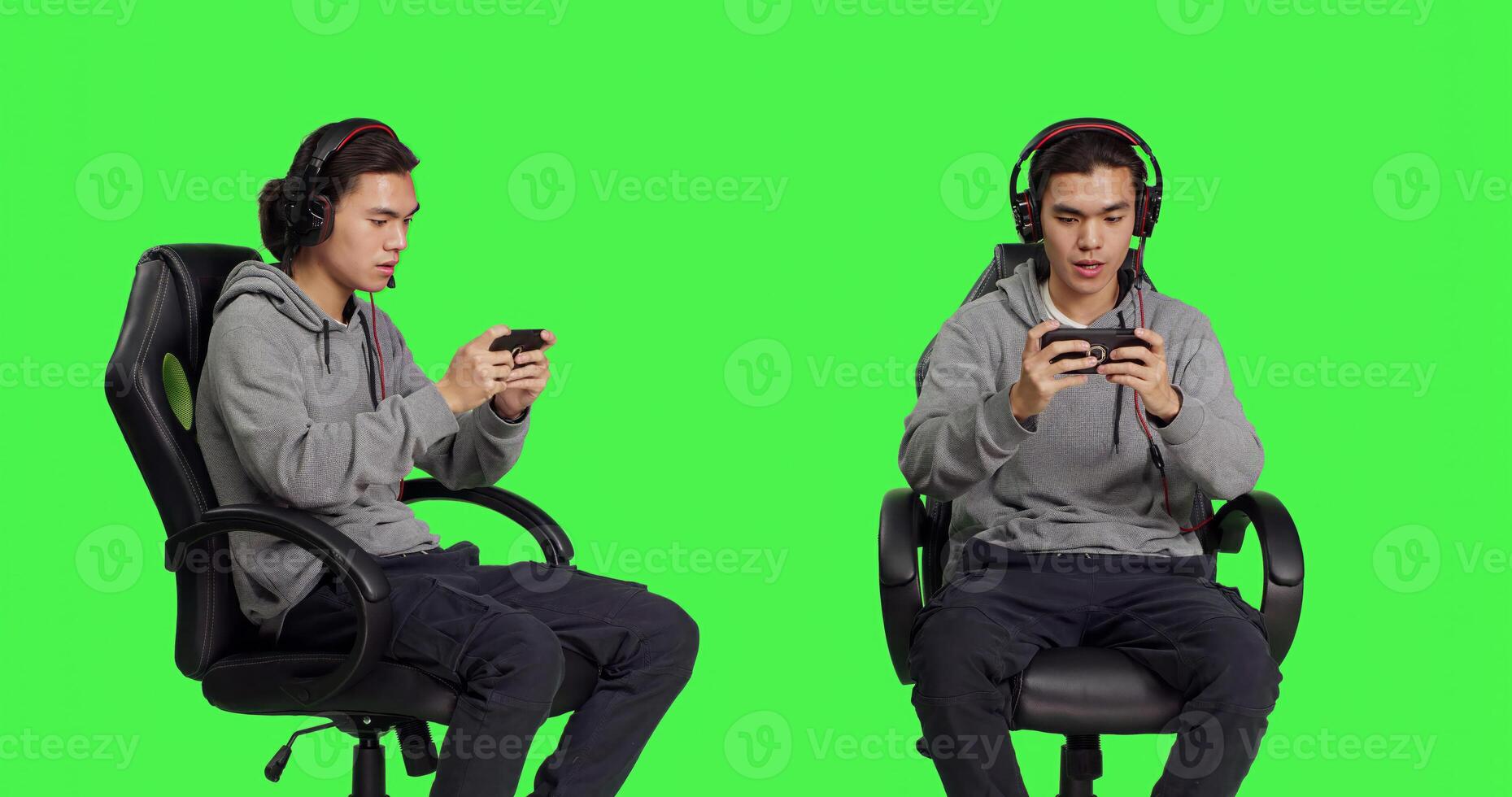 Asian young man plays mobile games over greenscreen, holding smartphone to play online multiplayer competition. Gamer using phone device to have fun with new rpg gameplay on chair. photo