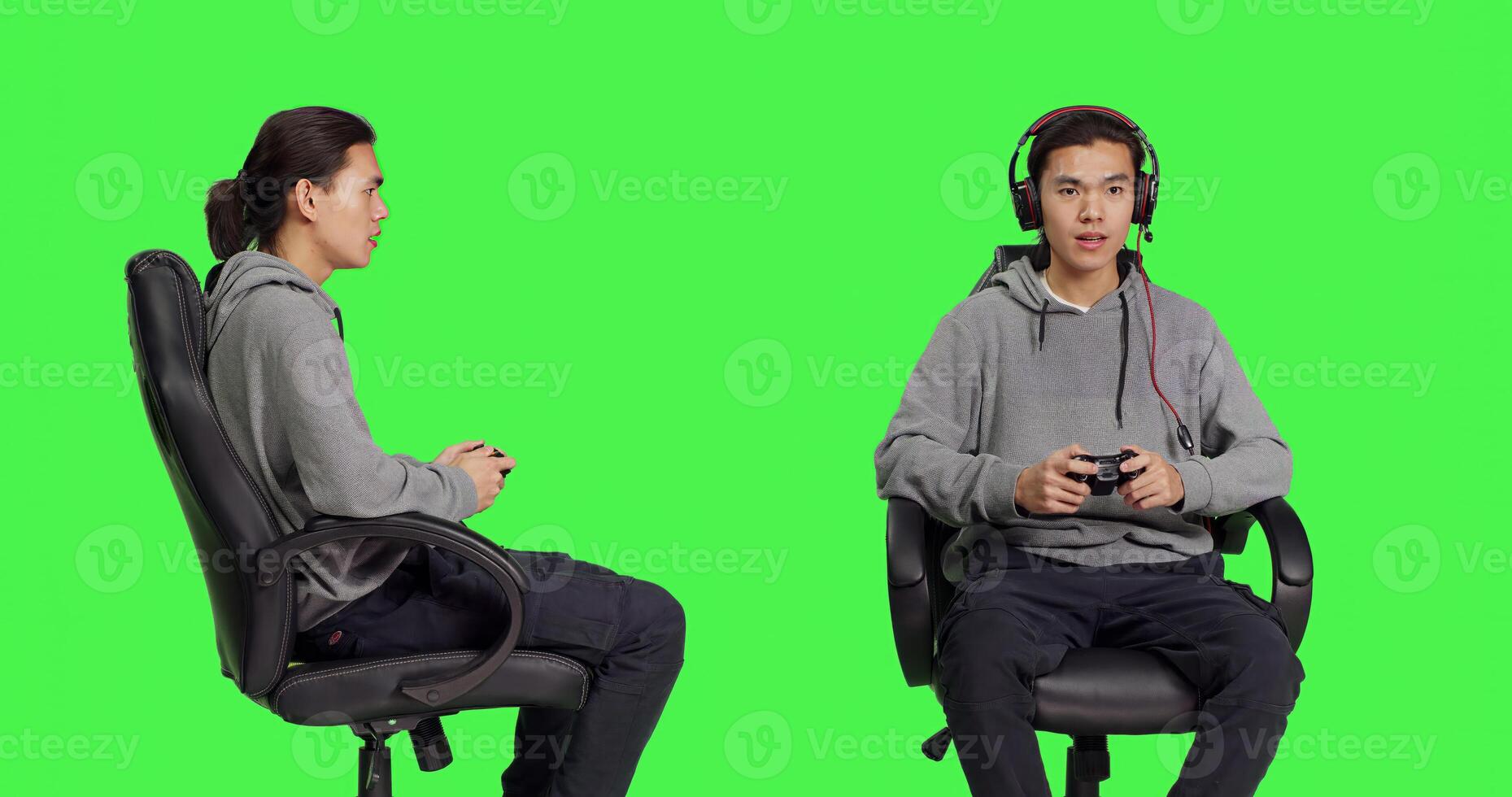 Asian man using joystick for gameplay, sitting on chair against greenscreen backdrop in studio. Young adult enjoying online gaming challenge with friends, gamer playing games. photo
