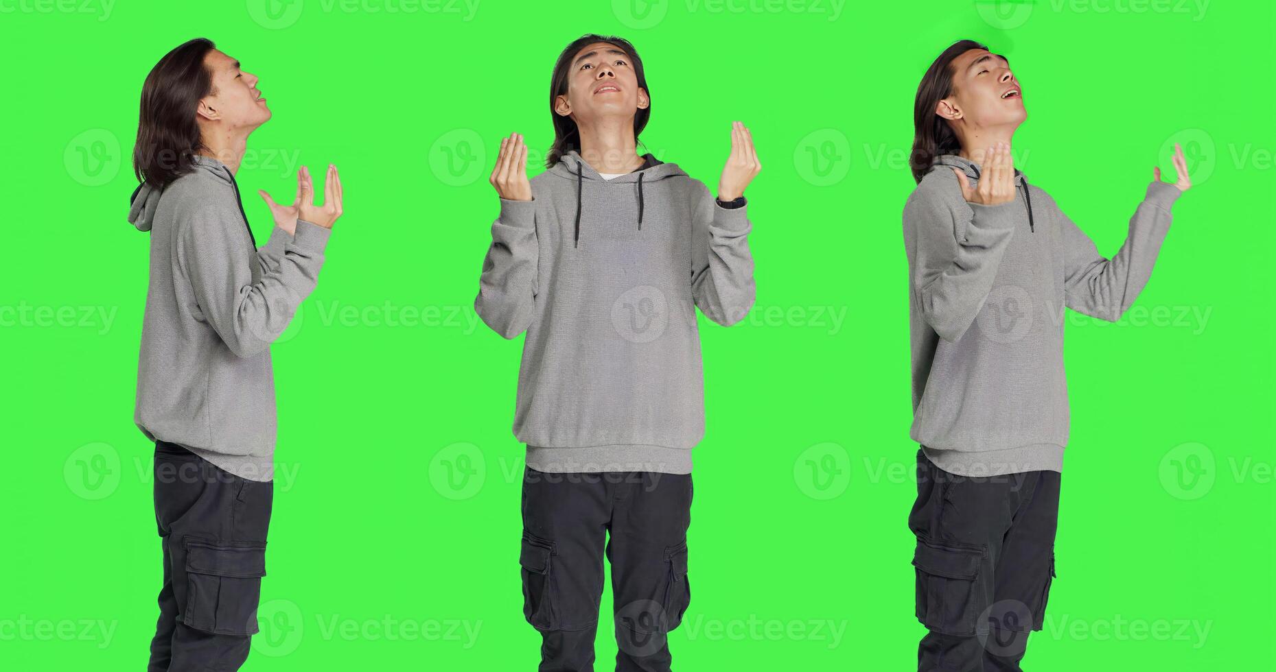 Model with belief praying to God against greenscreen studio backdrop, hoping for fortune and good things. Young religious man acting spiritual with prayer, feeling hopeful. photo