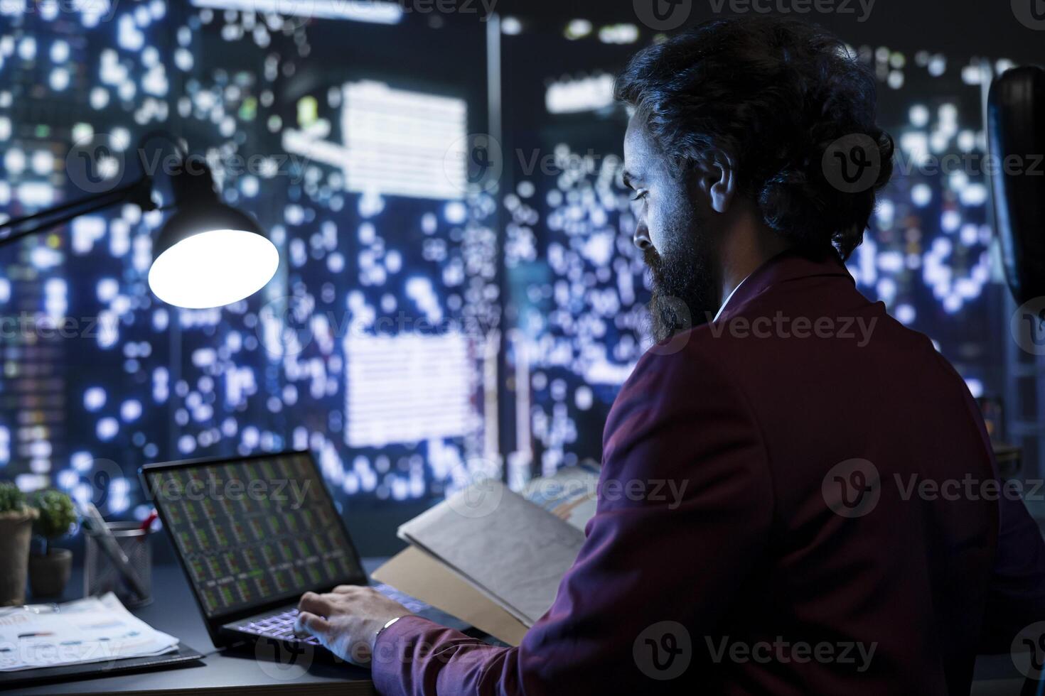 Director of finance working after hours searching for strategies to boost earnings, reviewing legal folder documents in company headquarters. Business counselor confirming legitimate fiscal duties. photo