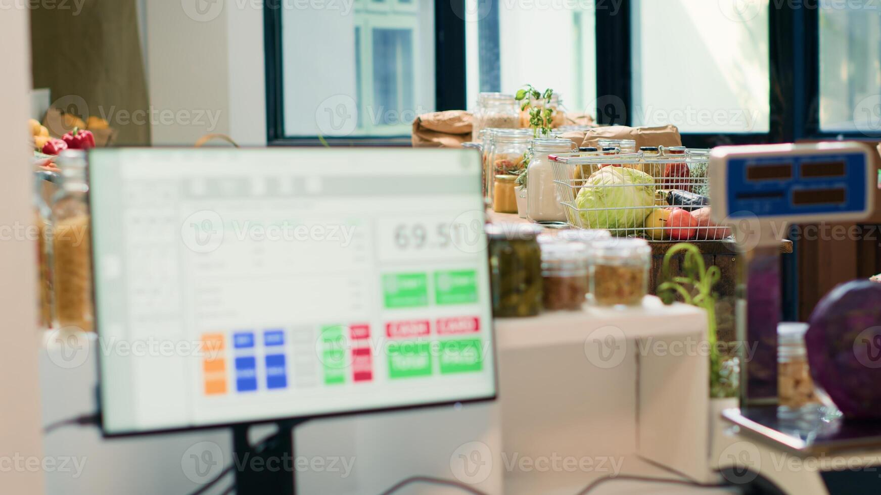 Low carbon footprint food in local supermarket, checkout counter with cash register used to purchase natural herbs or organic produce. Fruits, vegetables, grains, spices and pasta on display. photo