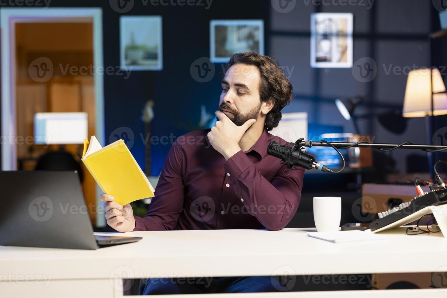 Content creator in studio reviewing newly released hardcover book from publisher, giving feedback on story. Reading hobbyist filming literature essay for new novel, analyzing characters photo