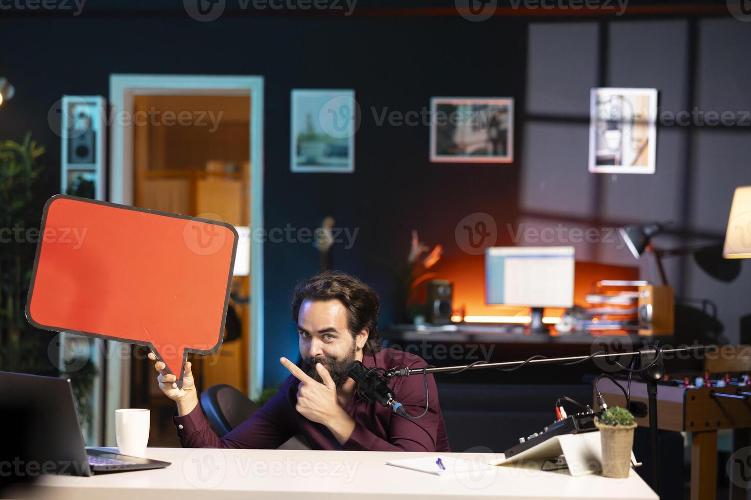 Influencer filming sponsored content, holding empty copy space sign in hand, talking to audience. Internet star using cardboard bubble speech cutout to do promotion to viewers photo