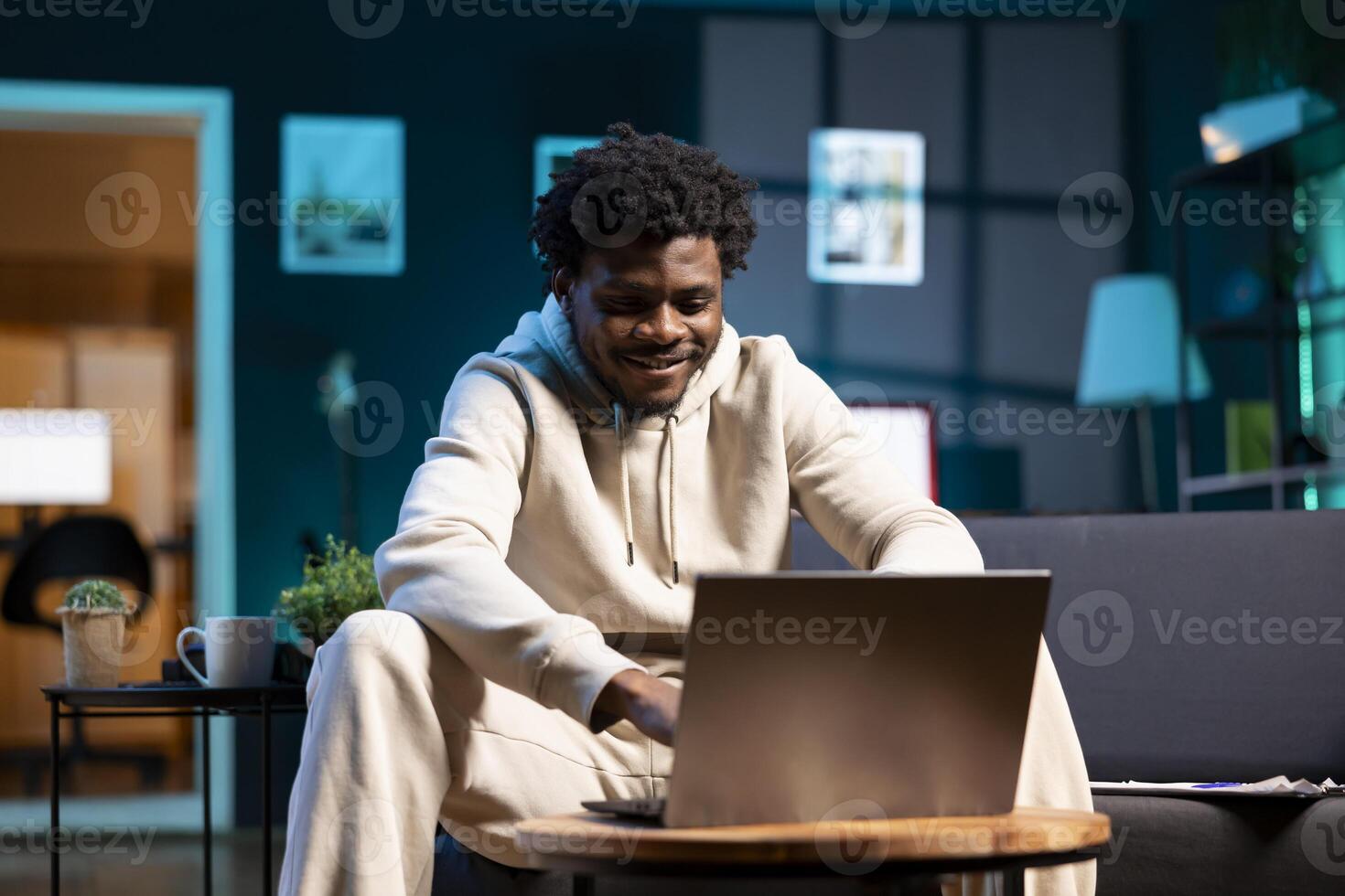 Cheerful freelancer working from home using laptop to send emails. Smiling remote employee typing on notebook keyboard, delivering finalized project paperwork to management photo