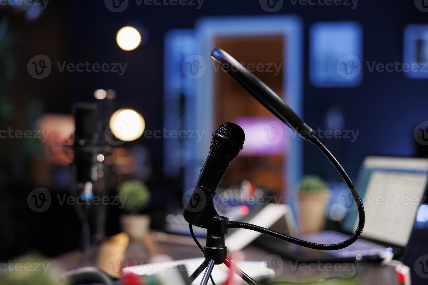 Closeup of a professional microphone with condenser filter in an empty vlog broadcasting studio being used to record social media content. Detailed view of audio live broadcast digital microphone. photo