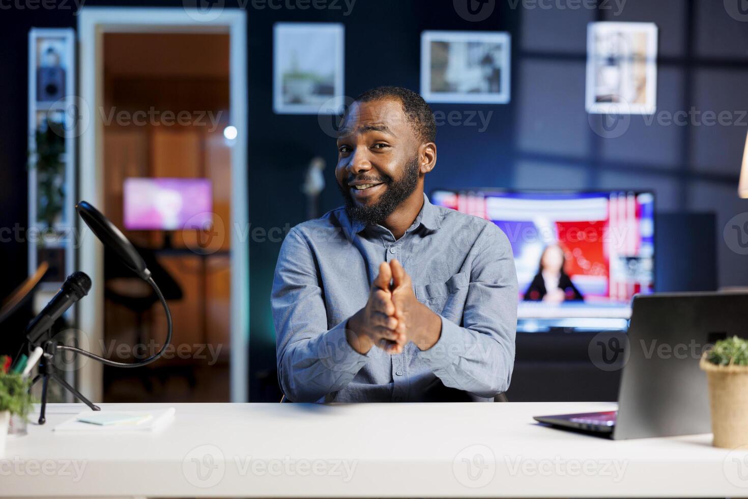 African american content creator doing story time type of for fans, filming in his apartment. Online show host telling viewers about captivating events to keep viewers engaged photo