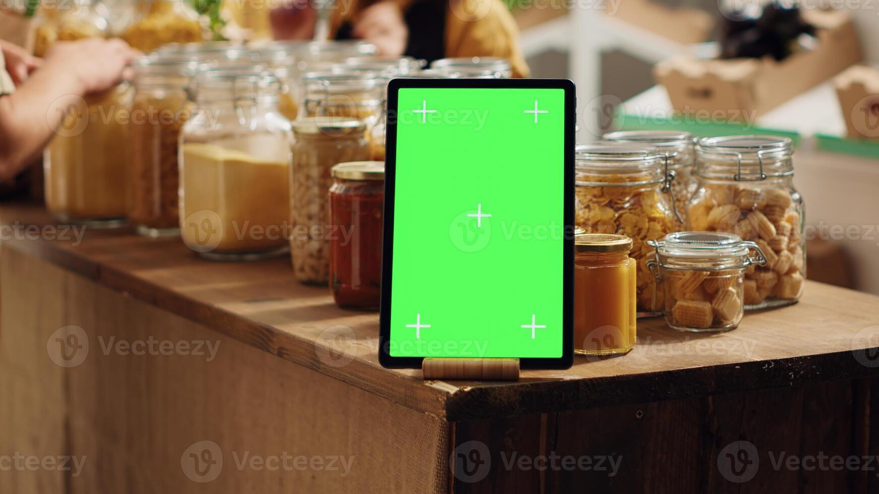Mockup tablet with empty copy space used as commercial sign in zero waste supermarket, close up. Isolated screen device acting as promotional message in food store with biodegradable packaged products photo