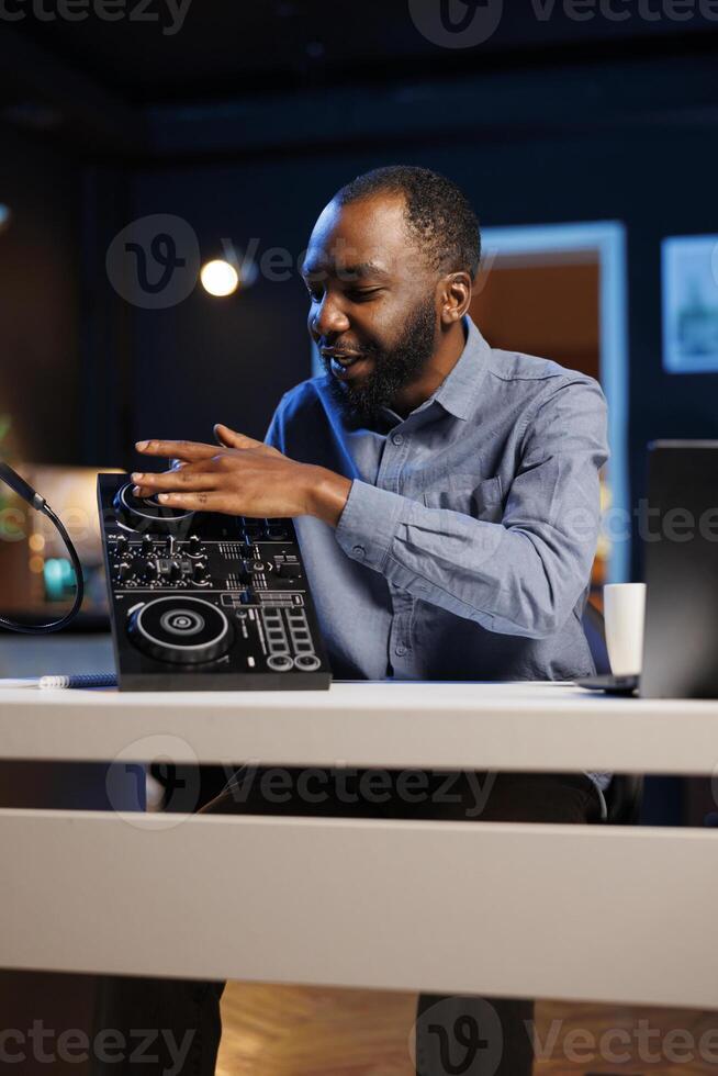 Content creator doing giveaway for his online channel subscribers, offering DJ controller device to most loyal fan. Media star happy to gift viewers professional sound mixer, doing contest photo
