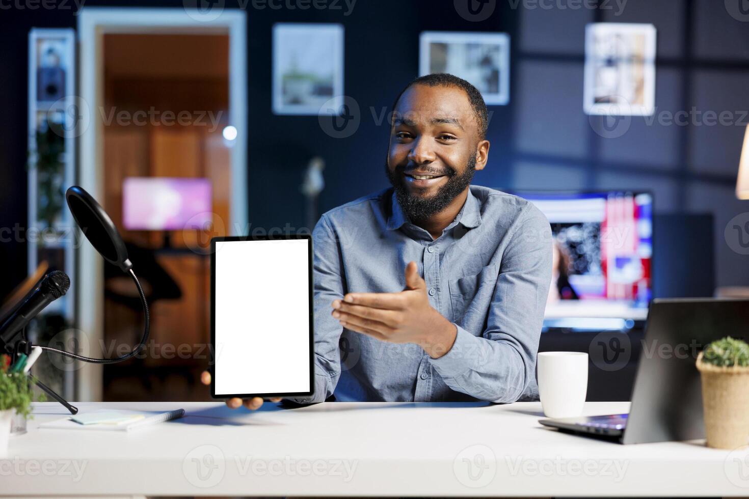 Technology expert at home holding newly launched isolated screen tablet in hand, presenting camera and screen specs. Media star doing mockup digital device review for viewers photo