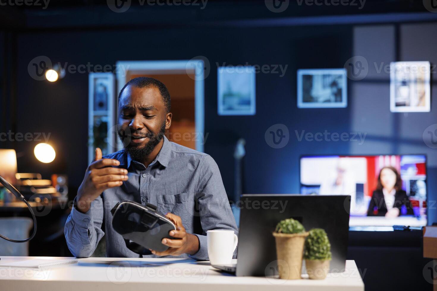 Tech influencer filming sponsored branded content, unboxing newly released VR glasses product. Cheerful entertainer presenting virtual reality headset parameters to subscribers photo