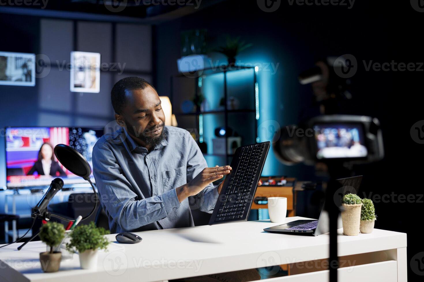 Media star assessing gaming keyboard, expressing dissatisfaction with subpar materials used. Content creator shooting review for online channel, displeased with low quality computer peripheral photo