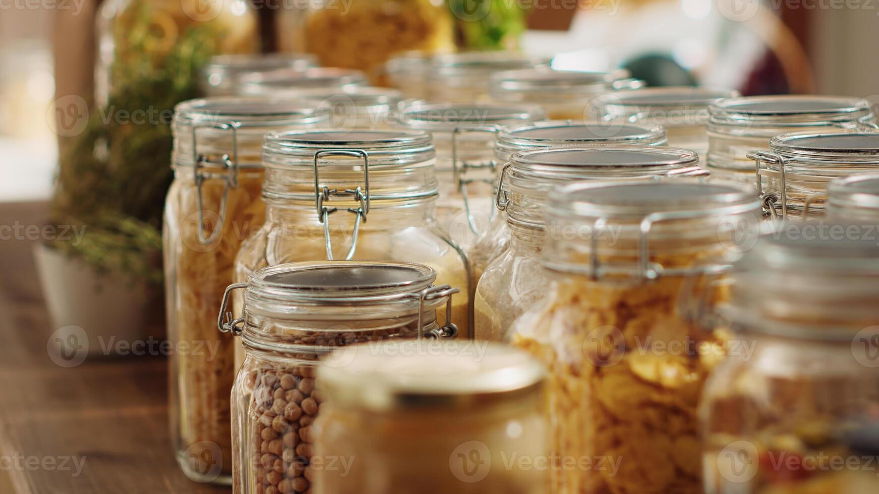 Close up on bulk products in reusable glass jars used by zero waste supermarket to eliminate single use plastics. Local shop pantry staples in sustainable packaging, zoom in shot photo